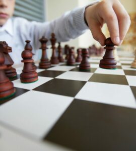Boy making chess move