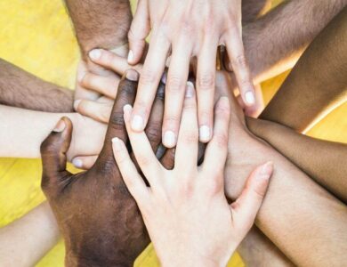 Top view of multiracial stacking hands