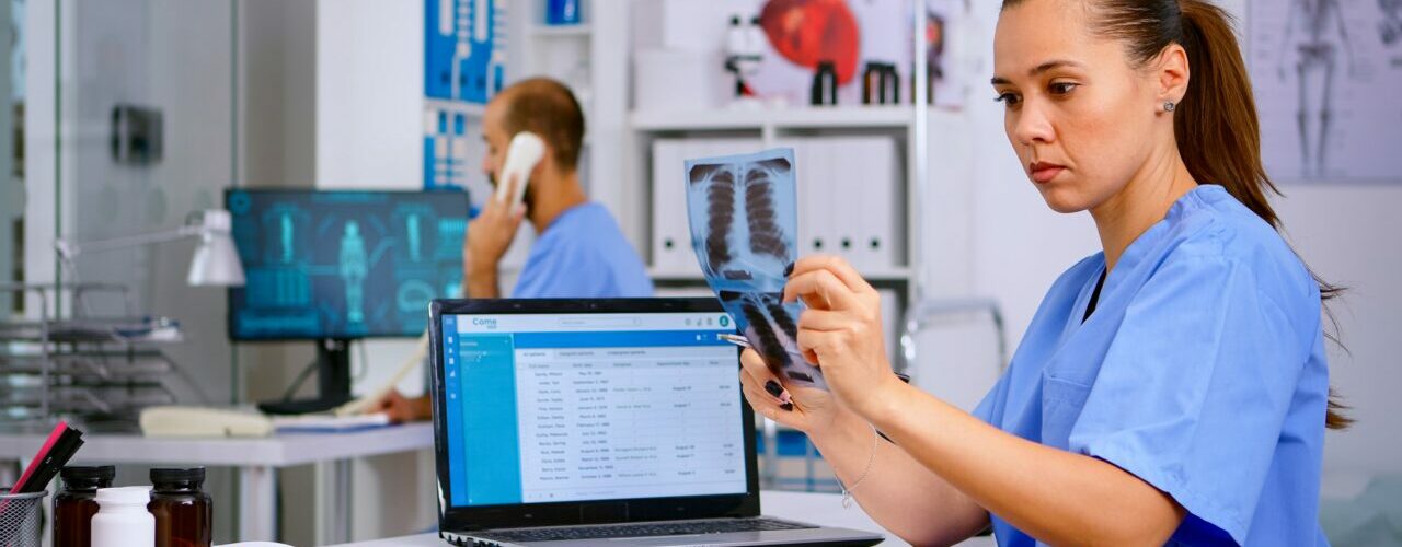 Medical doctor nurse holding and analysing radiography