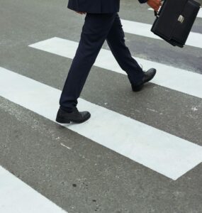Businessman crossing road