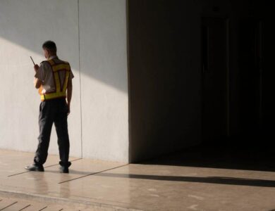 Security guard using walkie talkie while working in underground of parking garage