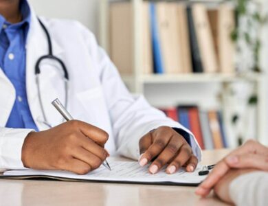 African black doctor consult woman patient filling medical form at appointment.